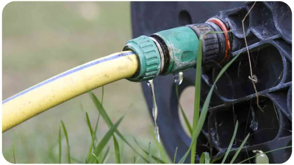 a hose is attached to a green hose in the grass