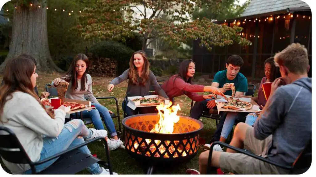 a group of people sitting around an outdoor fire pit