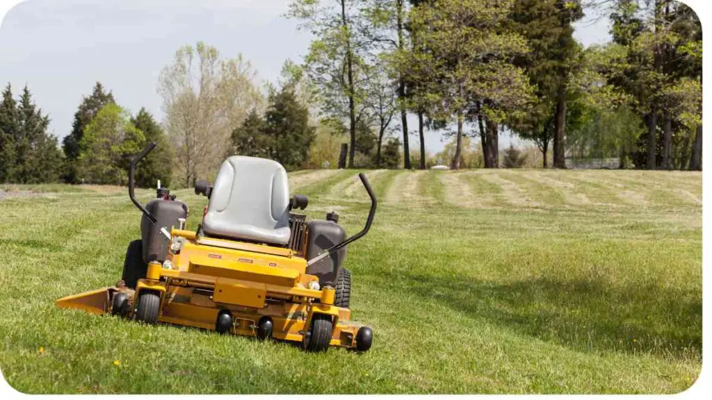 a yellow lawn mower sitting on top of a grassy field