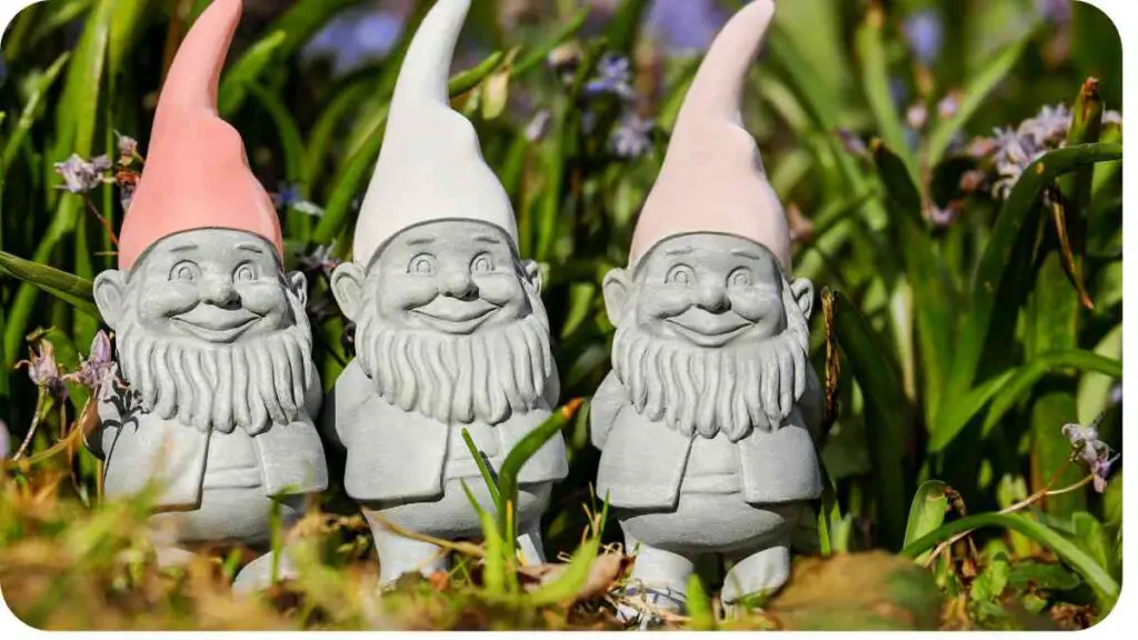 three gnome figurines are standing in the grass
