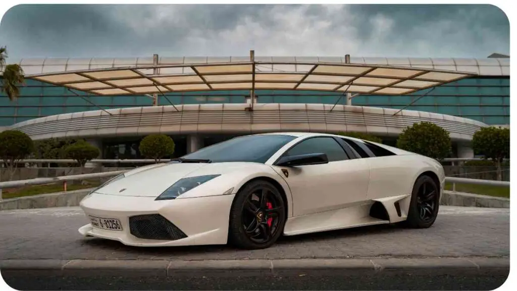 a white sports car parked in front of a building