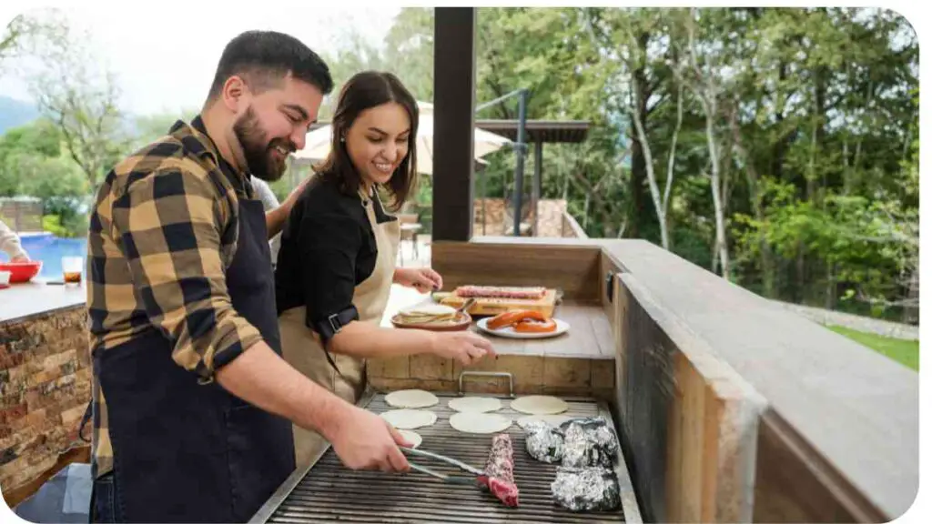Two people are cooking on an outdoor grill