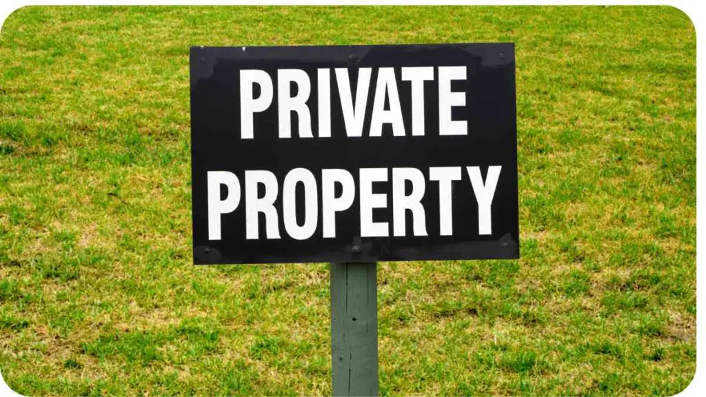 a private property sign in a grassy field