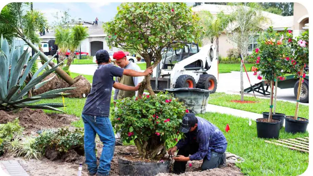 two people working on a landscaping project in front of a house