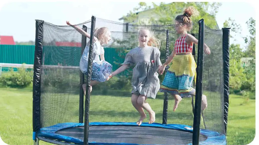 two children jumping on a trampoline in a yard
